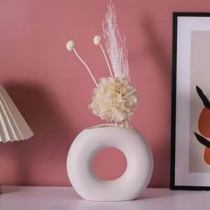 Donut-shaped ceramic flower vase in beige matte finish