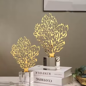 Decorative golden metal leaf sculpture with transparent base