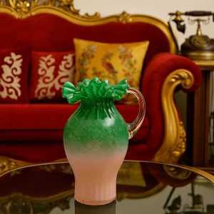 Handblown pink and green ruffled glass vase with curved handle