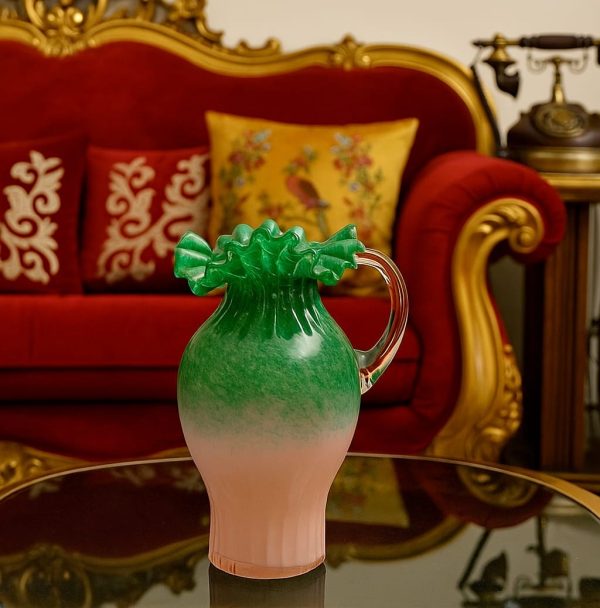 Handblown pink and green ruffled glass vase with curved handle